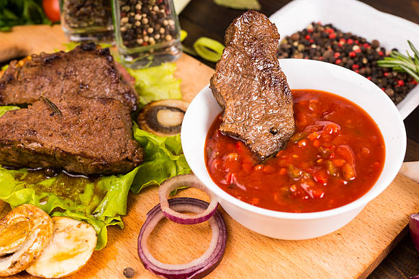 istock Pieces of Beef with Salsa and Fresh Herb Seasoning 515854526