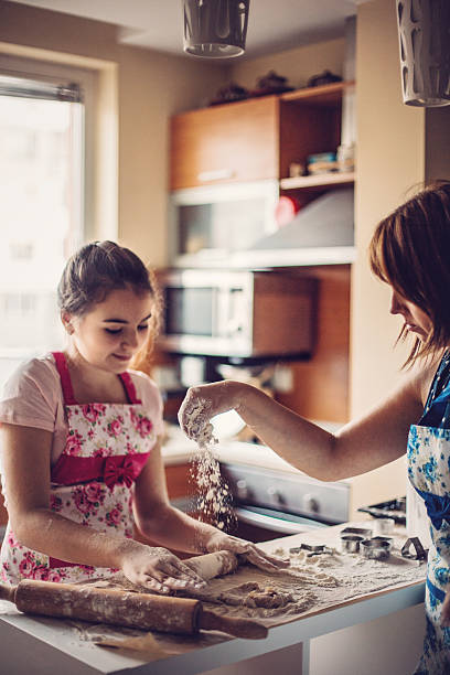 istock Mother and daughter making dough 515855126
