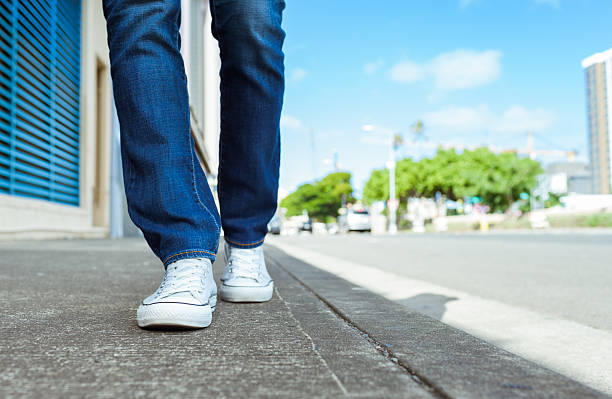 Woman walking down the street Woman walking down the street.  personal perspective standing stock pictures, royalty-free photos & images