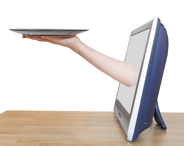 istock female hand with empty black plate leans out TV 515862115