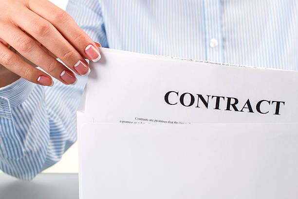 istock Female hand takes contract letter. 515862362