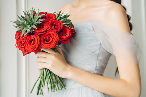 The bride holding wedding bouquet. Bright wedding bouquet in hands of the bride