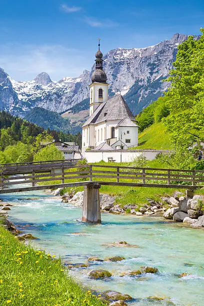 Scenic mountain landscape in the Bavarian Alps with famous Parish Church of St. Sebastian in the village of Ramsau in springtime, Nationalpark Berchtesgadener Land, Upper Bavaria, Germany.