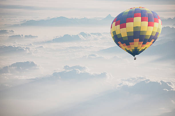 istock Hot air balloon flying over snowcapped mountain 515864568