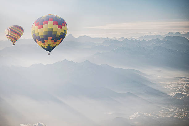 istock Hot air balloon flying over snowcapped mountain 515864698