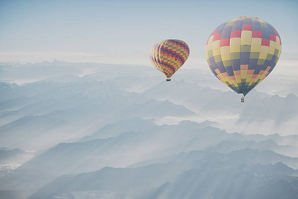 istock Hot air balloon flying over snowcapped mountain 515881742