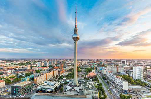 Berlin skyline panorama with famous TV tower at Alexanderplatz and dramatic cloudscape at sunset, Germany.