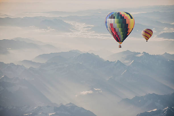 istock Hot air balloon flying over snowcapped mountain 515882058