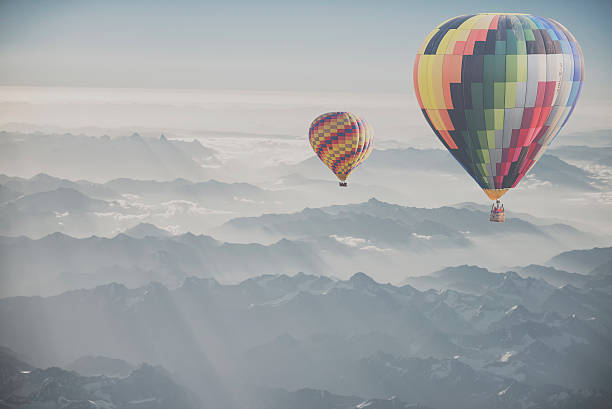 istock Hot air balloon flying over snowcapped mountain 515882170