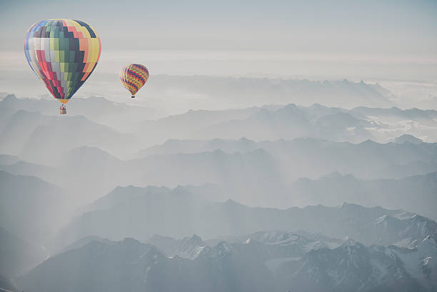 istock Hot air balloon flying over snowcapped mountain 515882268