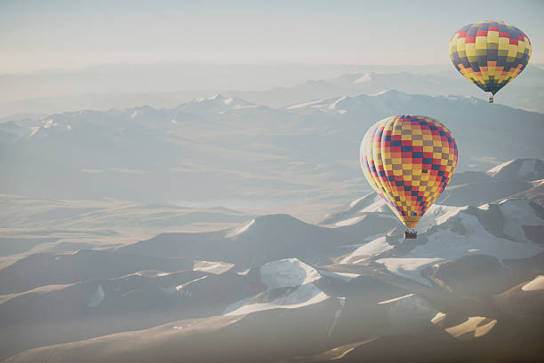 istock Hot air balloon flying over snowcapped mountain 515882414