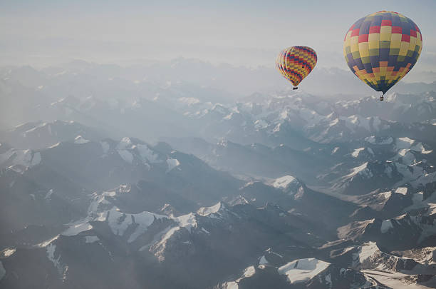 istock Hot air balloon flying over snowcapped mountain 515882726