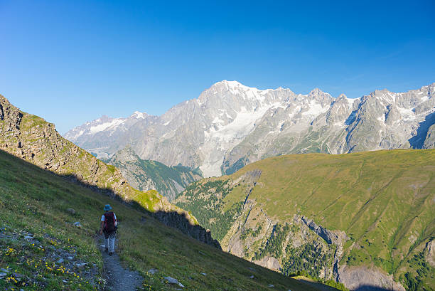 istock Backpacker hiking on the Alps, majestic Mont Blanc in background 515887302