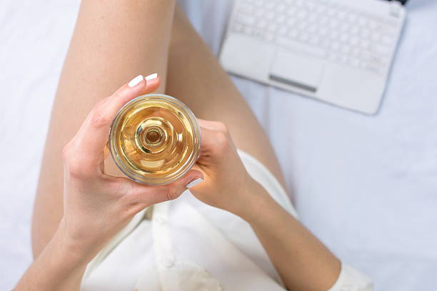 istock Woman having a glass of wine in bed 515888564