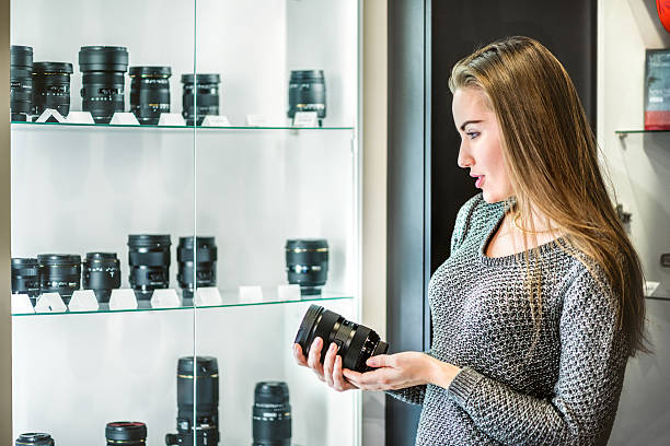 istock Woman is choosing camera lens 515889818