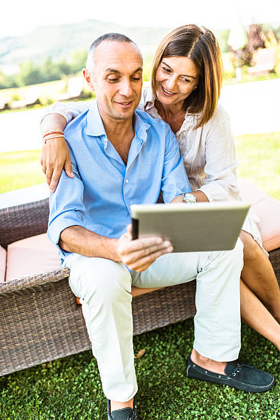 istock happiness mature couple embracing and surfing 515890022