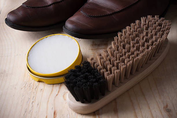 istock Shoe care. Shoe wax and brushes on wooden surface. 515890732