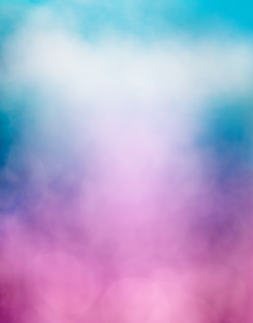 An abstraction of clouds and fog with a purple to blue gradient and subtle bokeh light effects.  Image is soft focus.
