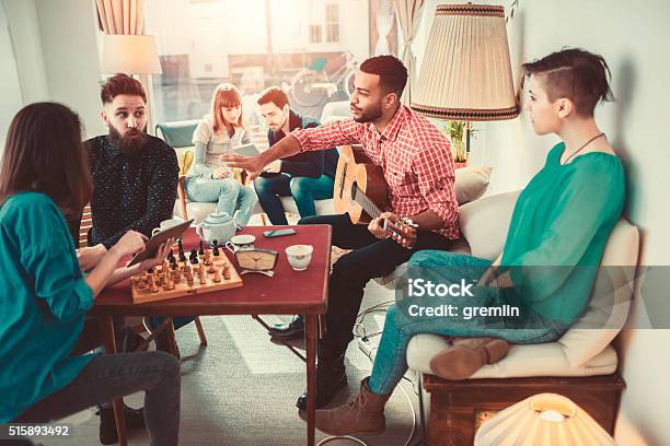Group Of Young Adults Having Fun In Coffee Shop Stock Photo - Download Image Now - Board Game, Friendship, Game Night - Leisure Activity