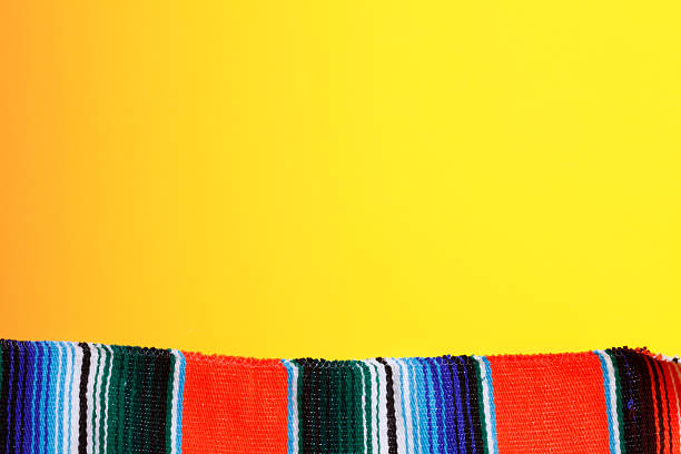 istock Multicolored Mexican Blanket On A Bright Yellow Background 515893738