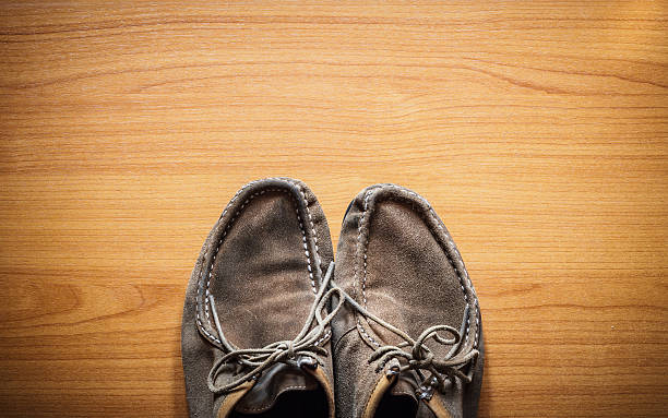 istock Brown leather shoes on wooden, top view 515894134