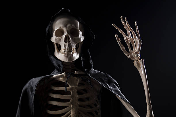 Grim Reaper waving with hand stock photo