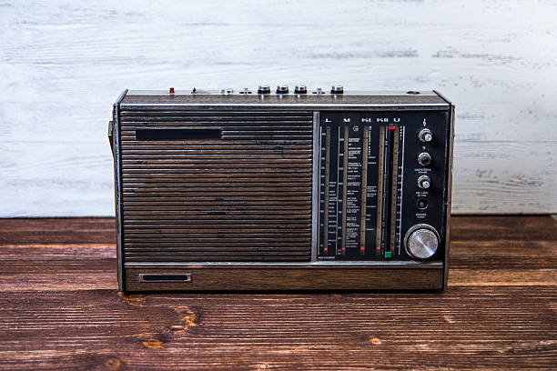 istock An old dark brown radio on wood table. 515909205