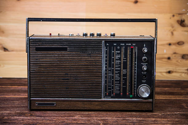 istock An old dark brown radio on wood table. 515911249