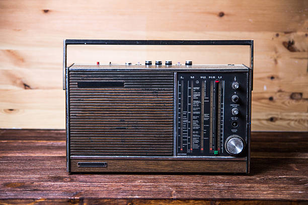 istock An old dark brown radio on wood table. 515911283