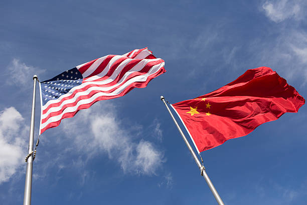 istock American Chinese windy day flags fly together on flagpole 515912126
