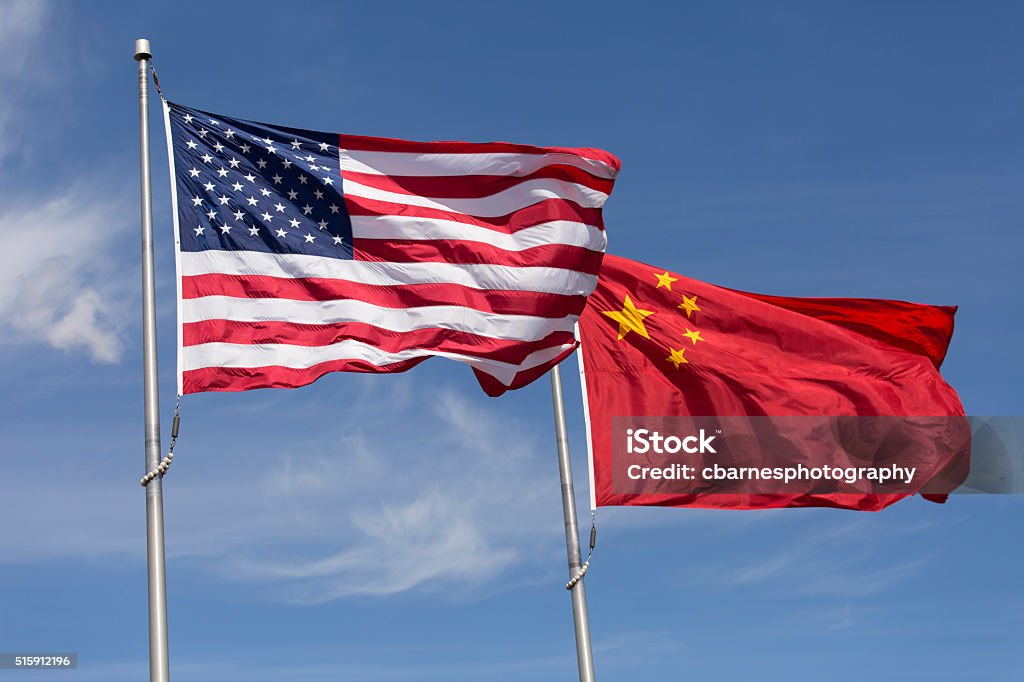 American Chinese windy day flags fly together on flagpole Symbolic of Sino-American relations, the flag of the United States of America and the flag of the Republic of China fly together on flag poles next to each other on a sunny, windy day. USA Stock Photo