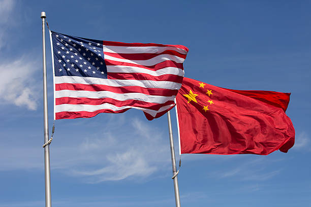 American Chinese windy day flags fly together on flagpole Symbolic of Sino-American relations, the flag of the United States of America and the flag of the Republic of China fly together on flag poles next to each other on a sunny, windy day. china stock pictures, royalty-free photos & images