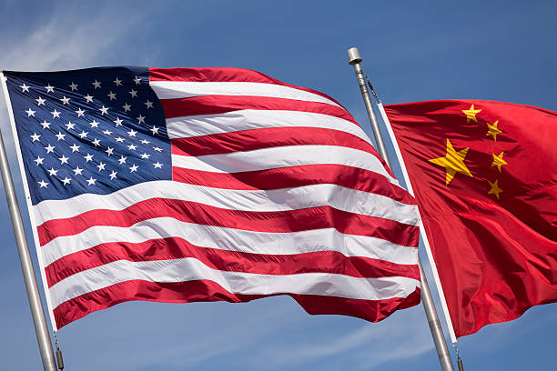 istock American Chinese windy day flags fly together on flagpole 515912266