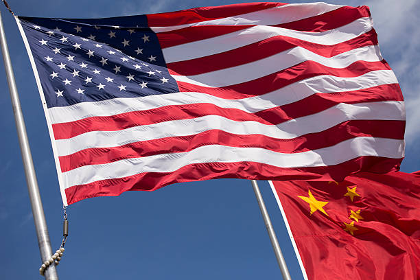 istock American Chinese windy day flags fly together on flagpole 515912342