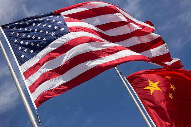 istock American Chinese windy day flags fly together on flagpole 515912384
