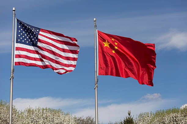 istock American Chinese windy day flags fly together on flagpole 515912498