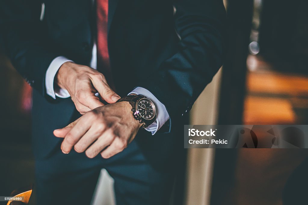 Well Dressed Man putting his wrist watch Watch - Timepiece Stock Photo