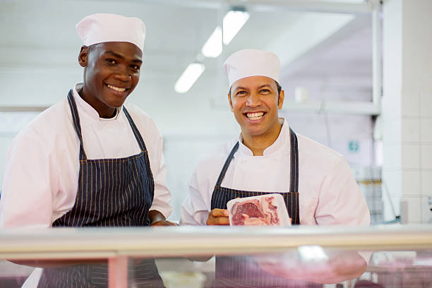 istock male butchers standing at butchery counter 515919730