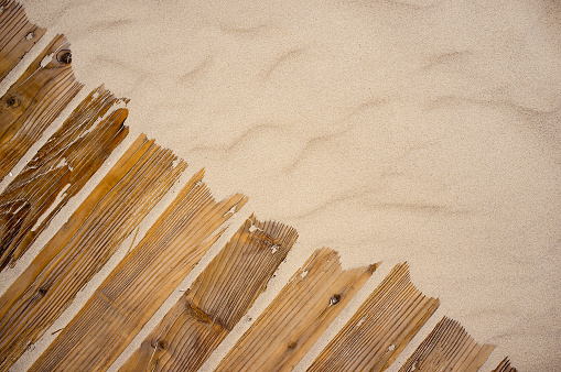 Sand on planked wood
