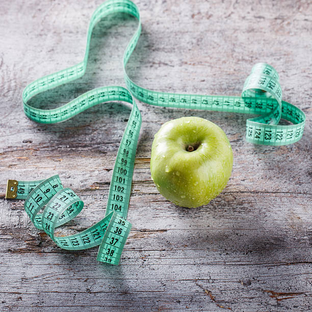 Green Apple and centimetre Green Apple and centimetre.Food or Healthy diet concept.selective focus. centimetre stock pictures, royalty-free photos & images