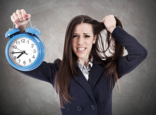 istock business woman with alarm clock 515922360