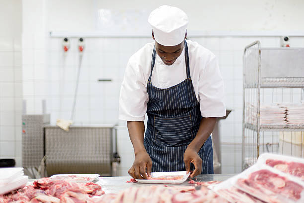 istock african male butcher packing meat 515922522