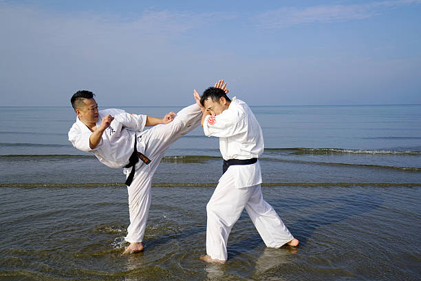 Kagawa, Japan - January 3, 2016: Japanese karate men training of karate fighting in midwinter of a new year at Ichinomiya Beach, January 3, 2016, Kagawa, Japan