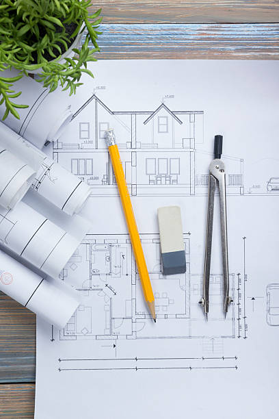 istock Architect worplace top view. Architectural project, blueprints, blueprint rolls and 515925274