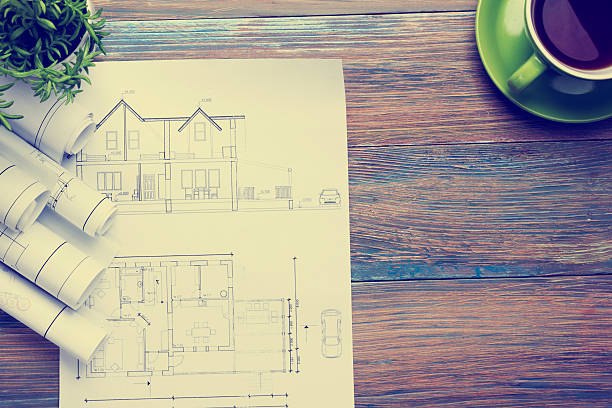 istock Architect worplace top view. Architectural project, blueprints, blueprint rolls and 515925400