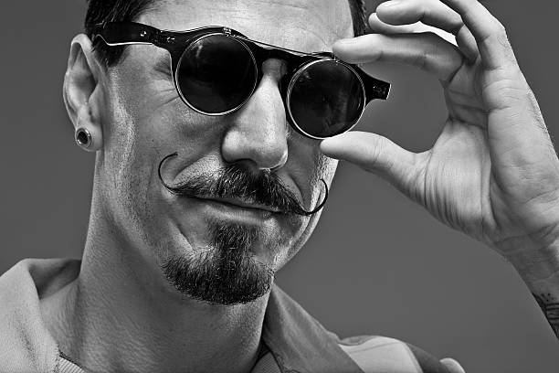 istock moustached man touching vintage sun glasses 515926423