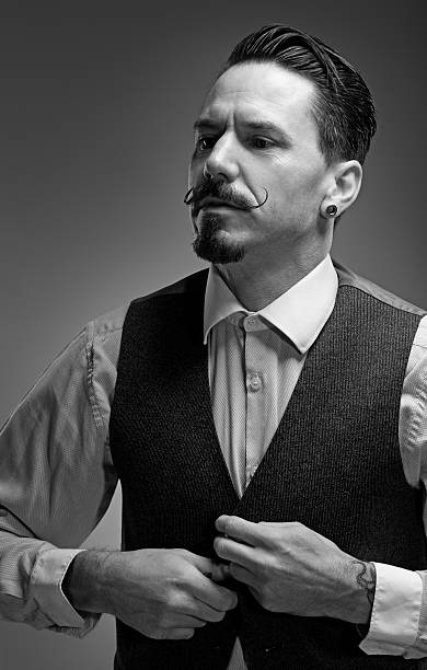 istock moustached man adjusting waistcoat 515926429