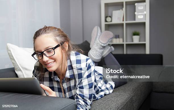 Using Digital Tablet On Sofa Stock Photo - Download Image Now - 20-29 Years, Adult, Adults Only