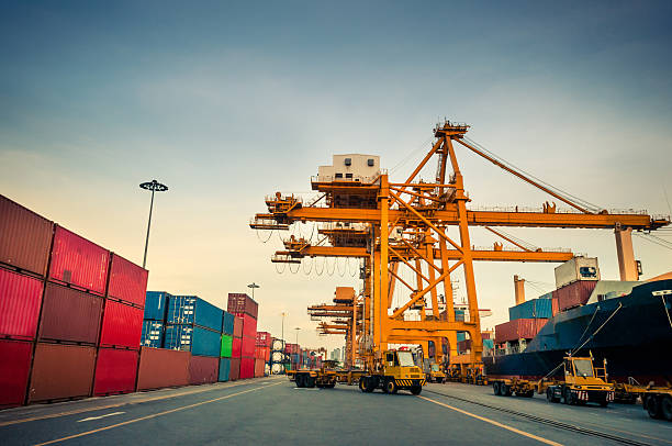 istock Cargo ship in the harbor at sunset . 515927277