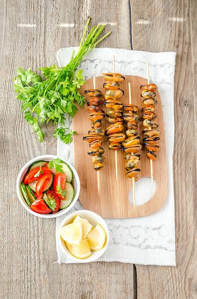 istock Mussel skewers with fresh salad 515960827
